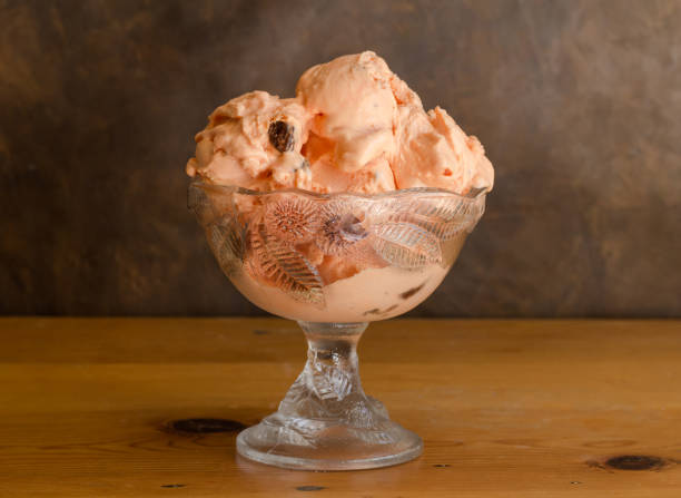 istock Rum and raisin icecream in glass bowl on rustic wooden table 1059951688