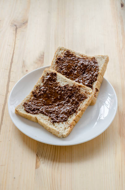 istock Pouring chocolate on a slice of bread 1059953520