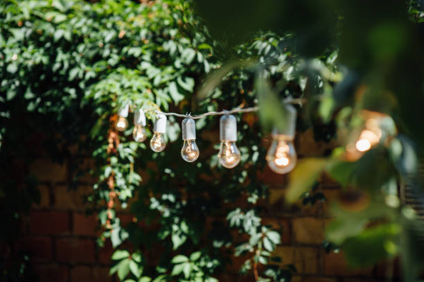 istock Light bulb decor in outdoor party. Party 1059955240