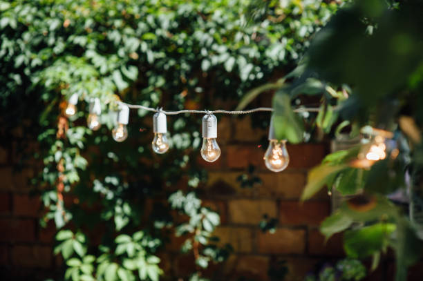istock Light bulb decor in outdoor party. Party 1059955272