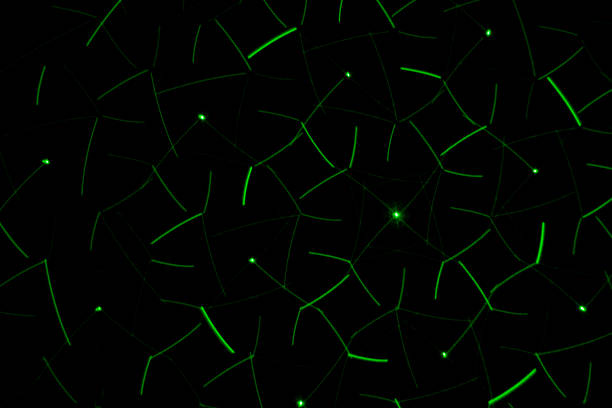 istock Drawing on a black wall with a green laser. Abstract drawing 1059955536