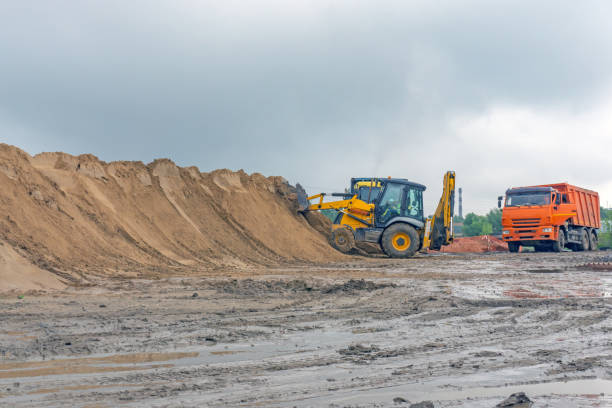 istock Bulldozer at a construction site forms a pile of sand 1059958362