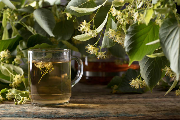 istock Linden tea and flowers on wooden table. 1059960812