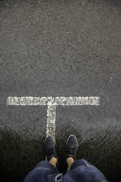 istock Feet on wet asphalt 1059966000