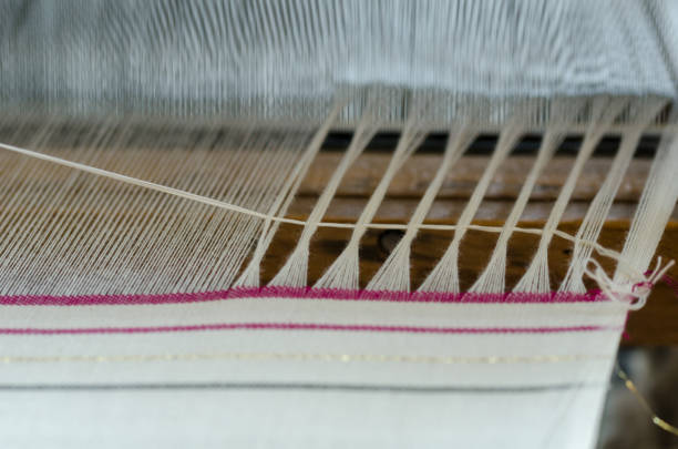 istock Engaged in production of handicraft textiles on the loom 1059971782