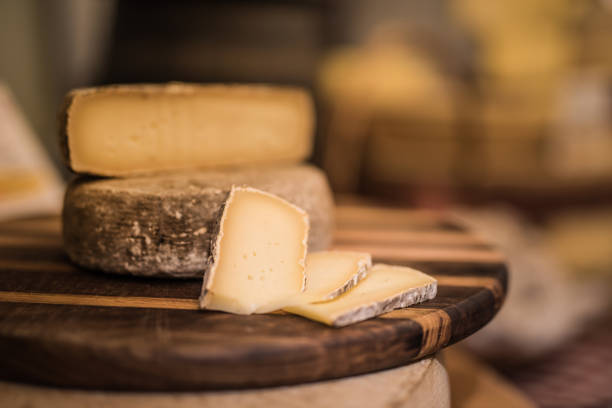 tomme de savoie, fromage de france (mountain cheese) on a white background