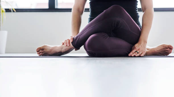 istock Middle aged woman doing yoga indoors 1059977746