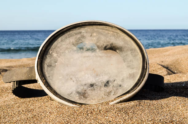 istock Diving Mask on the Sand Beach 1059978348