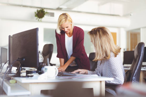 istock Businesswomen Discussing Over Documents At Desk 1059978410
