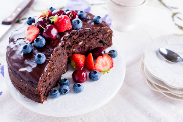 istock chocolate cake with fresh berries, on white background.Sweet dessert. Copy space 1059979522