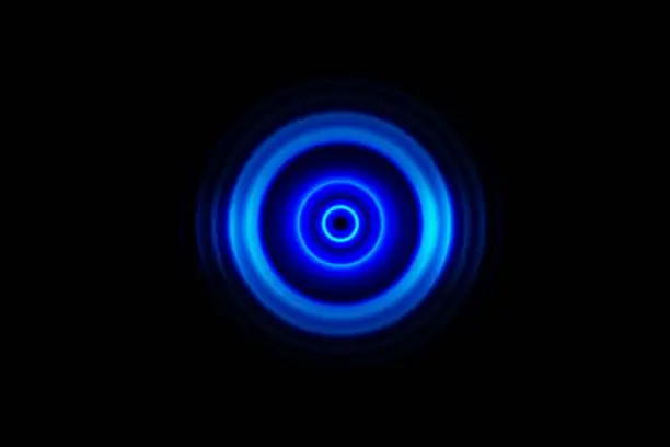Photo of Abstract dark blue ring with sound waves oscillating background