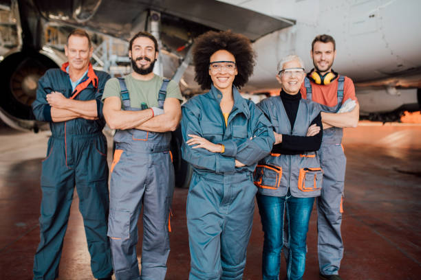 istock Group of people working at aircraft hangar 1059982118
