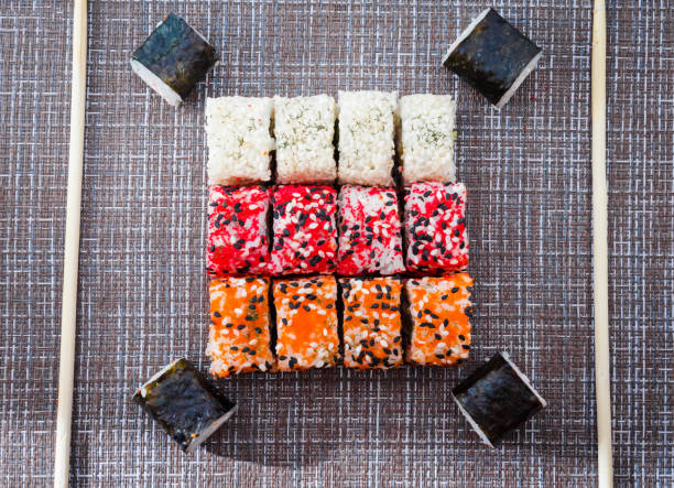 Sushi with chopsticks and soy sauce on traditional background