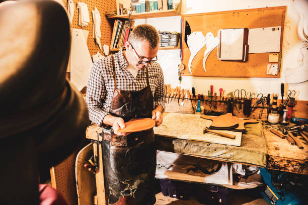 istock A saddle maker making a custom made saddle.  Real person, real life. 1059991814
