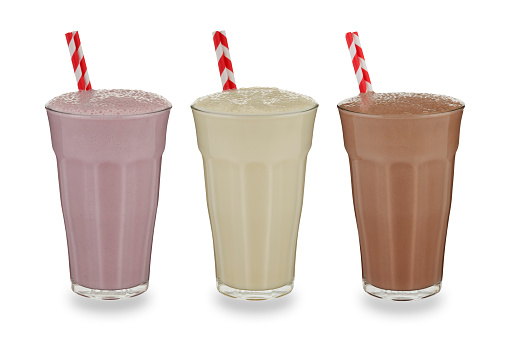 Strawberry, vanilla & chockolate milkshake, on white.