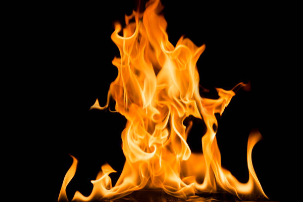 istock Fire flames on black background. Bright and colorful fire against a black night. 1059996394