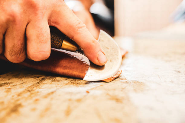 istock A saddle maker making a custom made saddle.  Real person, real life. 1059996760