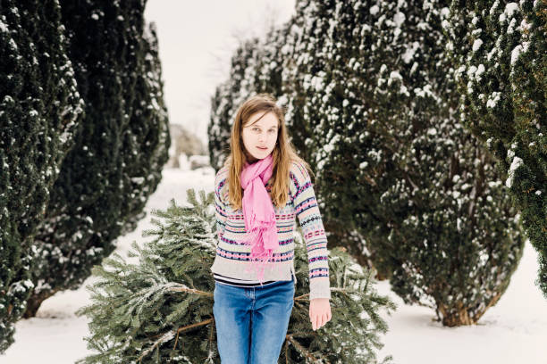 istock Teenage girl pulling her Christmas tree home. 1059999182