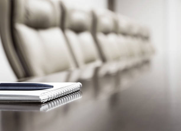 istock Close up of notepad kept on table in empty room 1060003054