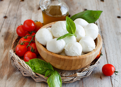 Italian cheese mozzarella with tomatoes, basil and olive oil - caprese salad