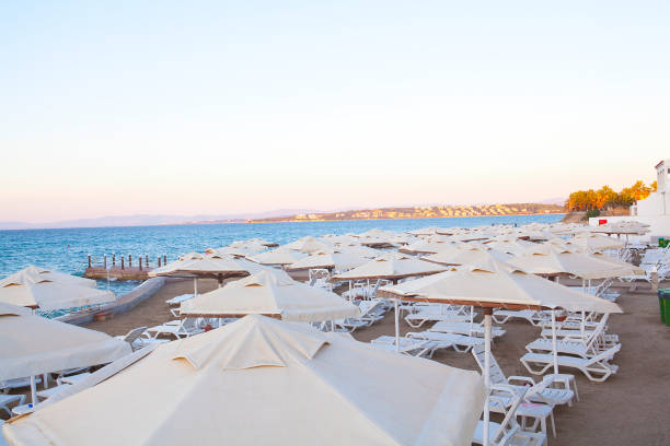 istock Beach chairs with beach umbrellas in a seashore on a sunny day. 1060006030