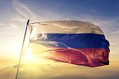 Russia Russian flag textile cloth fabric waving on the top sunrise mist fog