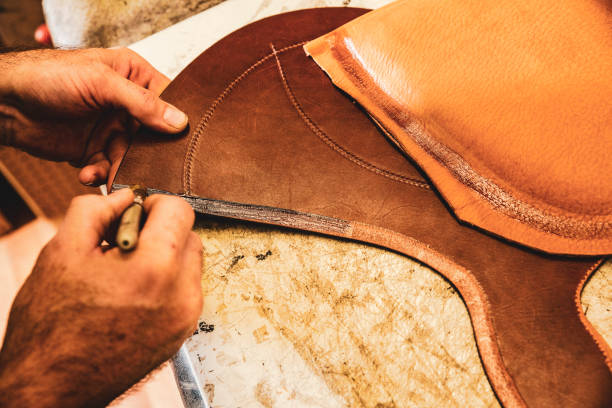 istock A saddle maker making a custom made saddle.  Real person, real life. 1060008450