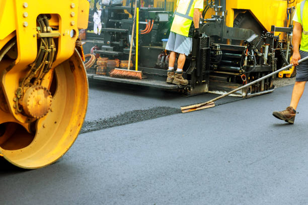 Road roller a road construction paver laying fresh asphalt pavement during road Road roller at a road construction site, paver laying fresh asphalt pavement during road compactor photos stock pictures, royalty-free photos & images