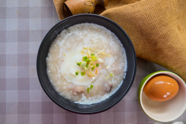 istock Rice porridge or congee with pork egg sliced ginger and vegetable. Delicious breakfast 1060010928