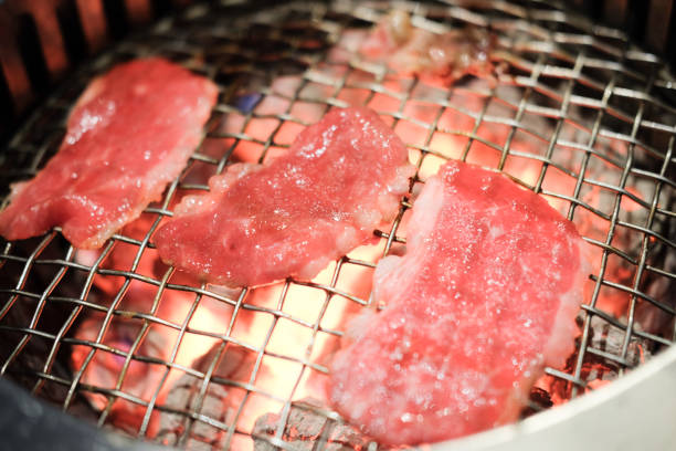 istock Grilled sliced meat on grille above fire charcoal 1060015136