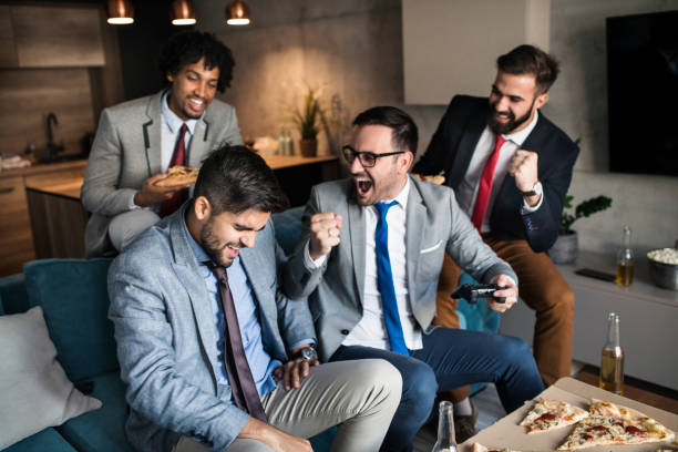 istock A group of young business man playing video games after work 1060016152