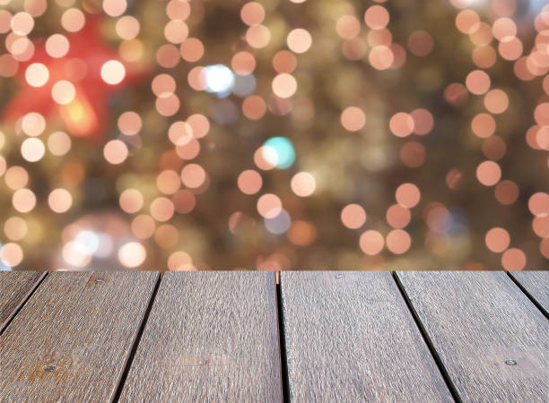 istock closeup empty dark brown wooden table top with defocused small colorful lights bokeh on Christmas tree background 1060017596