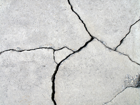 earthquake effect causes ground and wall to damaged, abstract texture background, closeup top view