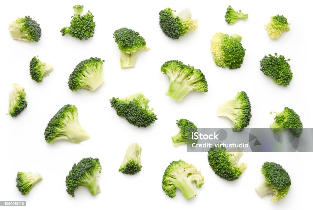 Broccoli pattern isolated on a white background. Various multiple parts of broccoli flower. Top view. Broccoli Stock Photo