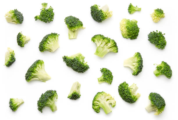 Broccoli pattern isolated on a white background. Various multiple parts of broccoli flower. Top view. stock photo