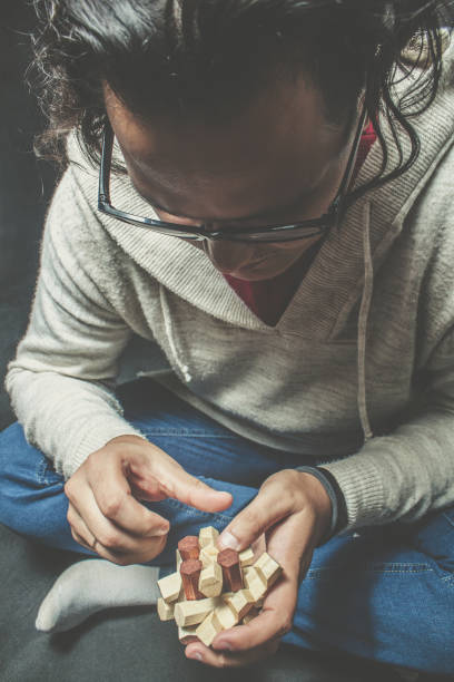 istock Smart guy with wooden puzzle 1060018608
