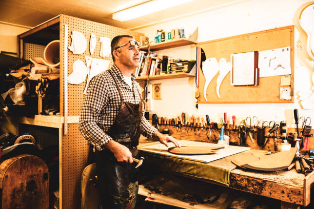 istock A saddle maker making a custom made saddle.  Real person, real life. 1060020294