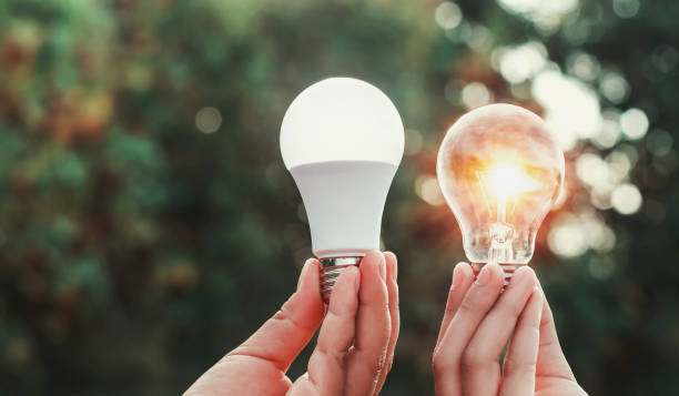 istock hand holding lightbulb and led light with sunset in nature background. concept energy power 1060020894
