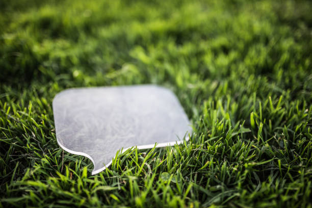 Transparent speech bubble on grass stock photo