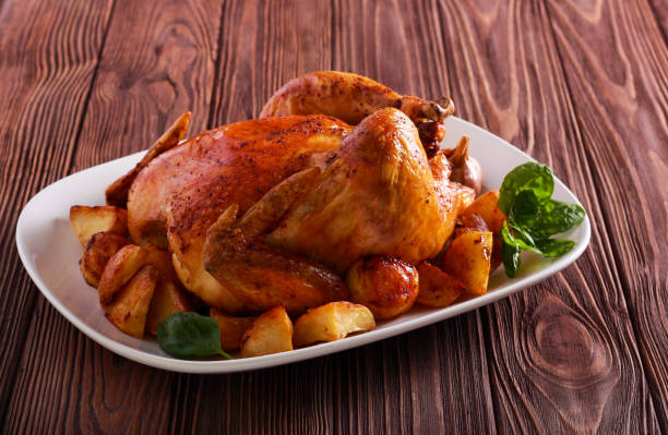 istock Roast chicken with potatoes on plate 1060021550