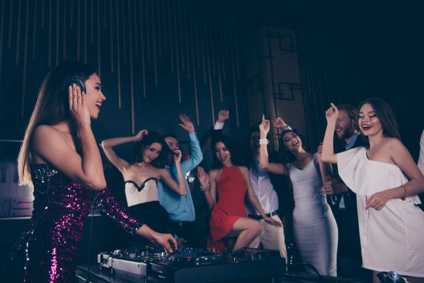 istock Deejay play song, audio record on modern vinyl player, while crowd dances on stage raising hands up and singing have good mood 1060025176