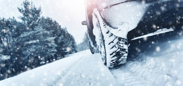 Closeup of car tires in winter on the road Closeup of car tires in winter on the road covered with snow road panoramic scenics journey stock pictures, royalty-free photos & images
