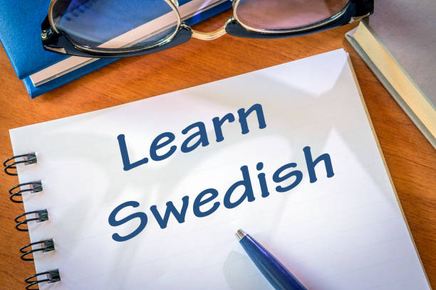 istock Learn Swedish written in a notepad. Education concept