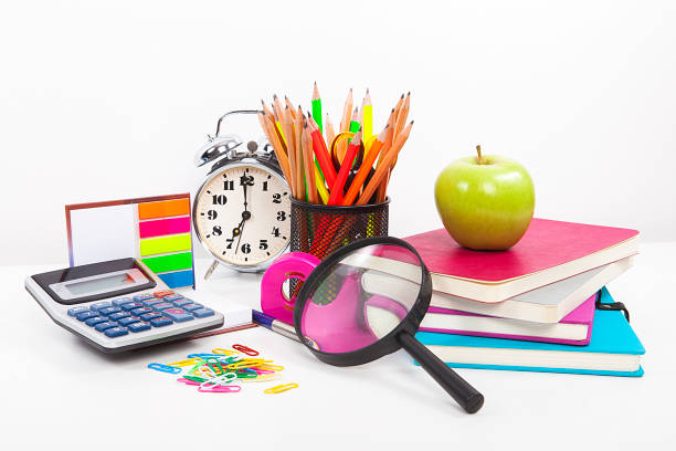 istock Colorful notebooks, office supplies and an apple on white background. 1060037024