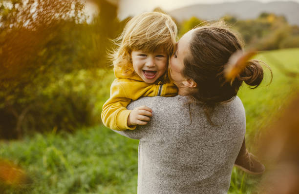 Toddler Playing With Mother Toddler Playing in a Children's Playground playing children stock pictures, royalty-free photos & images