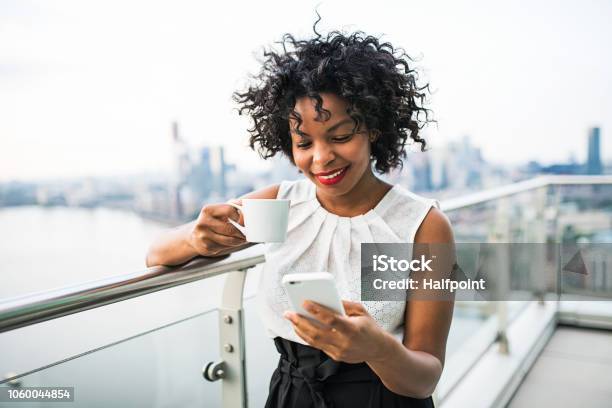 A Businesswoman With Coffee And Smartphone Standing Against London View Panorama Stock Photo - Download Image Now
