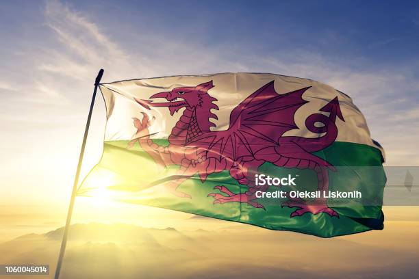 Wales Welsh United Kingdom Great Britain Flag Textile Cloth Fabric Waving On The Top Sunrise Mist Fog Stock Photo - Download Image Now