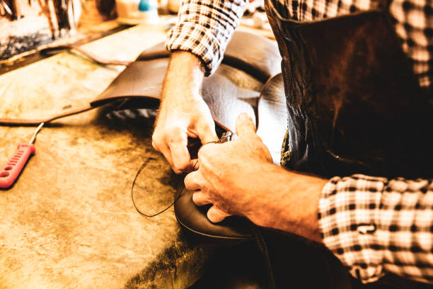istock A saddle maker making a custom made saddle.  Real person, real life. 1060045770