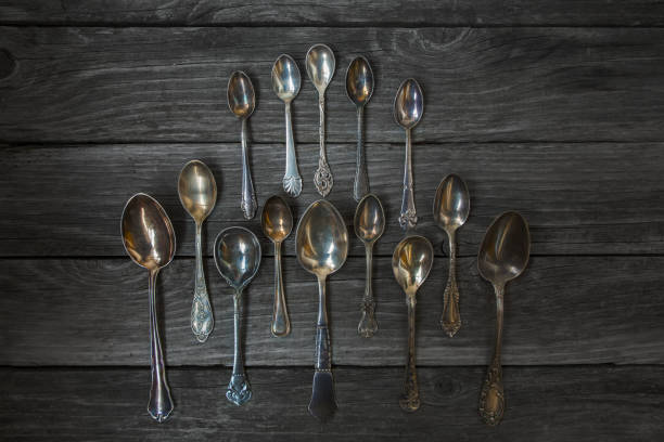 istock Vintage antique silver spoons on wooden background 1060046150