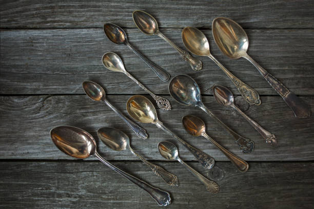 istock Vintage antique silver spoons on wooden background 1060046158